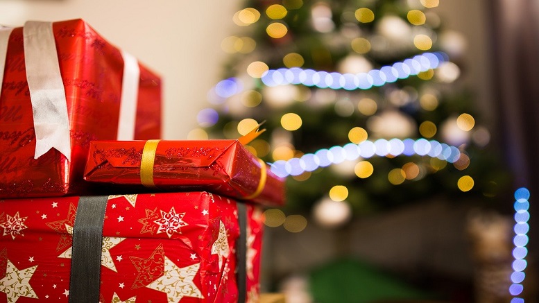 holiday season shopping, showing gifts with Christmas tree in the background