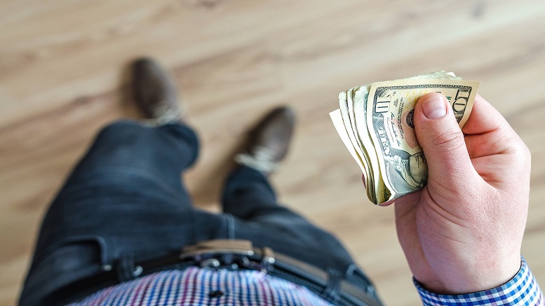 Cashback rewards in man's hand, showing money