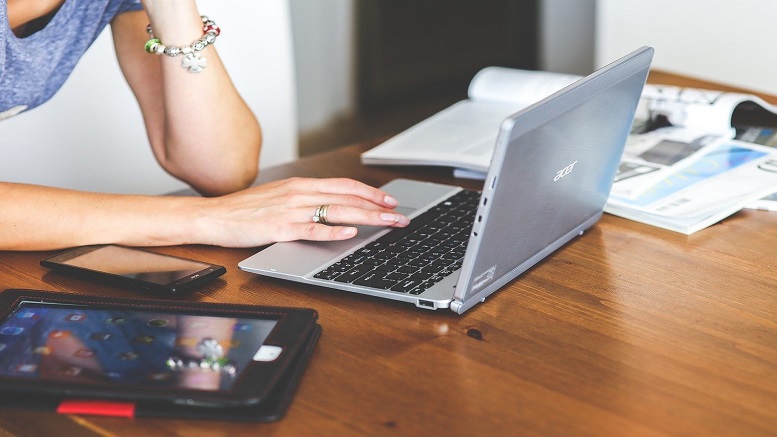 Woman using a laptop to take Qmee surveys