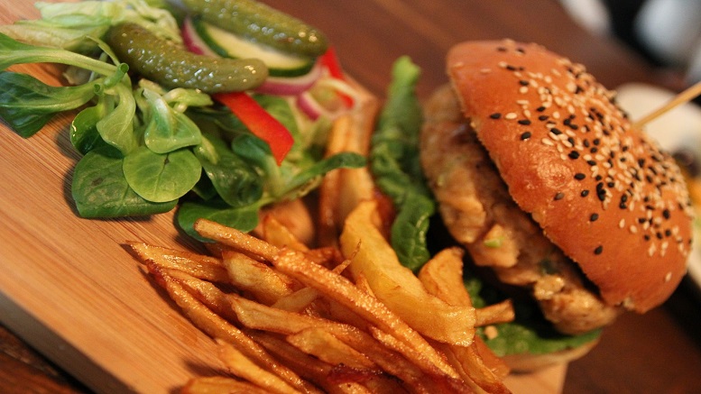 Cajun chicken burger with fries and salad