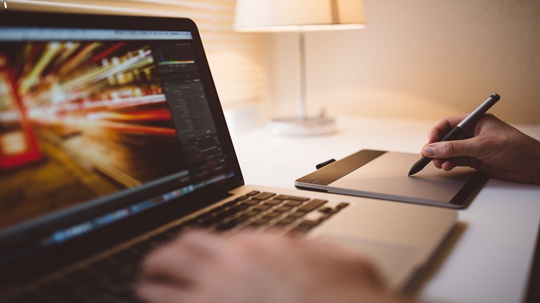 Person shown working at laptop to improve their personal brand and online reputation