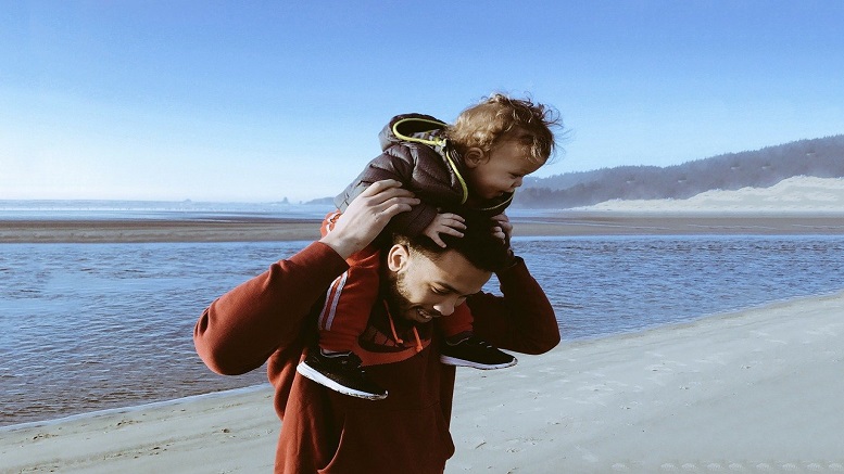 Image of father and child on a beach to represent Father's Day 2020