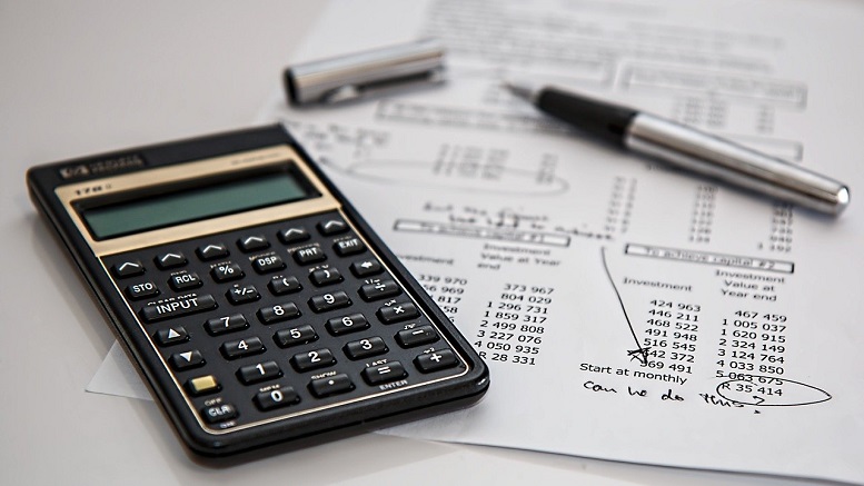 Calculator and savings showing dealing with finances