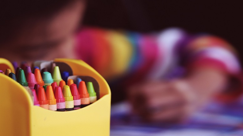 A child coloring with crayons when back at school