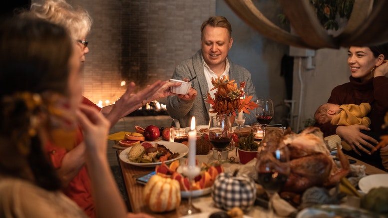 Family eating thanksgiving dinner to illustrate when yorkshire puddings are eaten.